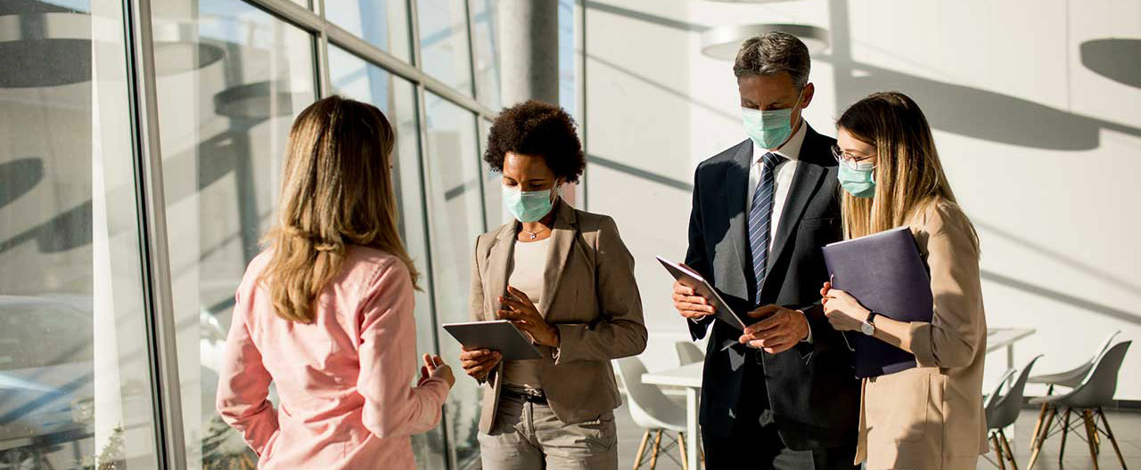 business people wearing masks in meeting