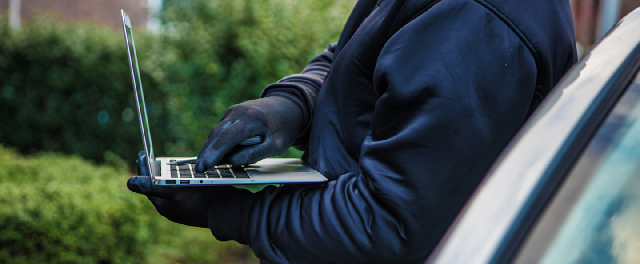 hacker beside car