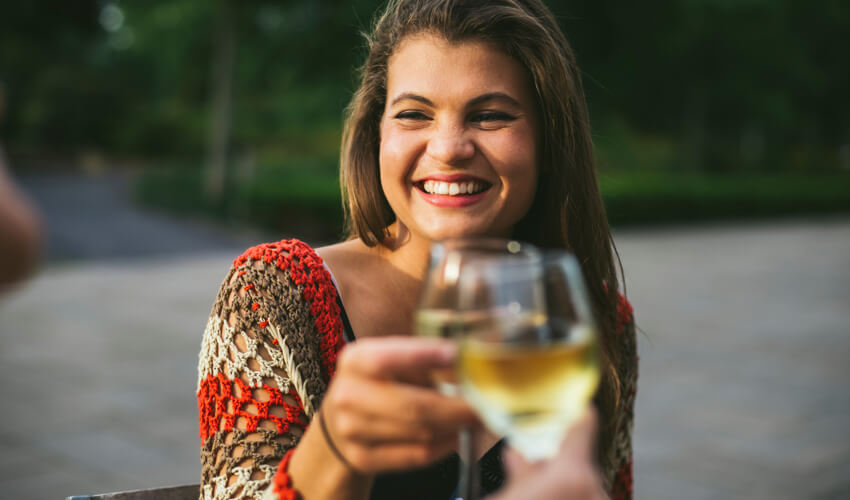 woman raises wine glass