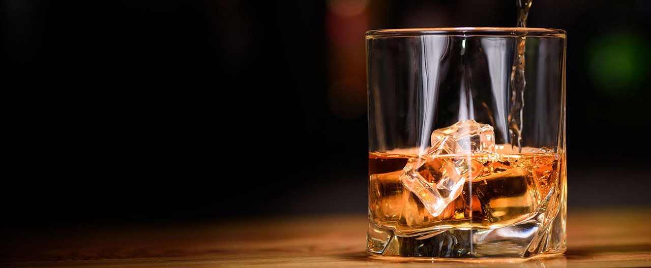 pouring whiskey to the glass